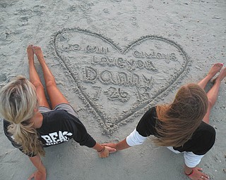 Samantha Wadman and Erin Lorimer made a tribute on the beach to their friend Danny Watkins on the one-year anniversary of his death.  He was loved by many of the kids in Boardman.