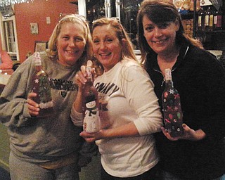 From left are Georgia Drouhard and Lori Ryzner, both of Berlin Center, and Sheryl O'Brien of Canfield, at Myrddin Winery in Lake Milton trying their hands at Christmas bottle painting. They have been friends for 40 years.