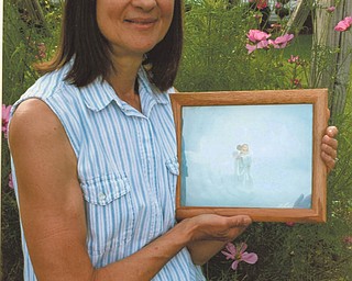 Marilyn Cavanaugh is holding a picture of her best friend, Jesus.