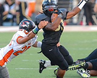 Jeff Lange | The Vindicator  Harding's Keemari Murry is brought down by Howland defender Victor Williams as he runs for a small gain for Harding, Friday night in Warren.