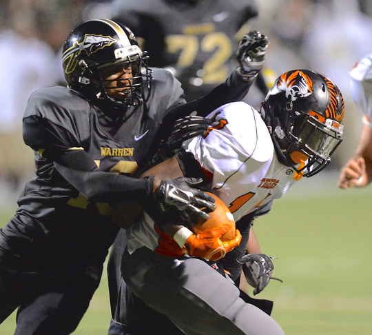 Jeff Lange | The Vindicator  Howland's Tyiq Ellis rushes for a small gain inside Harding's ten yard line as he is brought down by Mario Hainesworth of Harding, Friday night at Mollenkopf Stadium.