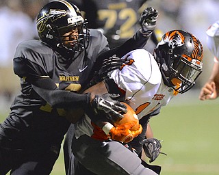 Jeff Lange | The Vindicator  Howland's Tyiq Ellis rushes for a small gain inside Harding's ten yard line as he is brought down by Mario Hainesworth of Harding, Friday night at Mollenkopf Stadium.