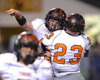 Jeff Lange | The Vindicator  Howland's John Dejacimo (facing) celebrates his fumble recovery in the third quarter against the Raiders Friday night with teammate Steve Baugh.