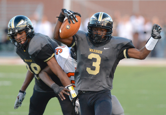Jeff Lange | The Vindicator  Warren sophomore Marlin Richardson runs down the Harding sideline for a Harding first down in the first half Friday night in Warren.