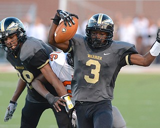 Jeff Lange | The Vindicator  Warren sophomore Marlin Richardson runs down the Harding sideline for a Harding first down in the first half Friday night in Warren.