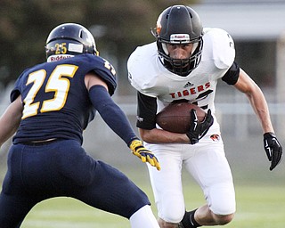 William D. Lewis The Vindicator  Springfield's Nate Simboli(22) eludes McDonald's Zack Conley(25) during Friday 9-5-14 action at McDonald.