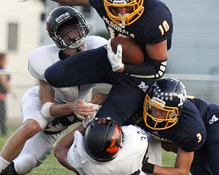 William D. Lewis The Vindicator McDonald's Cameron Ifft(10) is stopped by Springfield's Ian Grdnia(1) and Randy Groves(32). Blocking for McDonald at right is Austin Colburn(3).