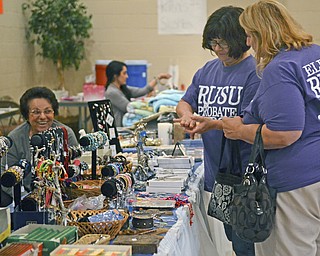 Katie Rickman | The Vindicator.Artemis Tirikou (on left) who is visiting from Greece smiles as Karen Seddon of Poland (center) and Susan Gifford of Canfield look at jewelry at the Greek Festival at Archangel Orthodox Greek Church in Campbell September 6, 2014.