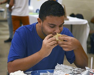 Katie Rickman | The Vindicator.Manoli Mavroudis, 15, of Campbell eats a gyro at the Greek Festival at Archangel Michael Greek Orthodox Church with friends September 6, 2014.