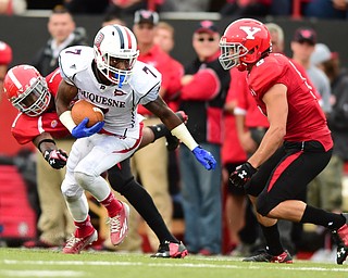 YOUNGSTOWN, OHIO - SEPTEMBER 6, 2014: Receiver Devin Rahming #7 turns upfield to slip a tack from defenders Julius Childs #1 and Donald D'Alesio #8 during the 4th quarter of Saturday afternoon game at Stambaugh Stadium. YSU won 34-23. (Photo by David Dermer/Youngstown Vindicator)