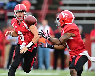 YOUNGSTOWN, OHIO - SEPTEMBER 6, 2014: Quarterback Dante Nania #3 of YSU pitches the ball to Andre Stubbs #4 during the 4th quarter of Saturday afternoon game at Stambaugh Stadium. YSU won 34-23. (Photo by David Dermer/Youngstown Vindicator)