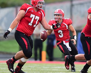 YOUNGSTOWN, OHIO - SEPTEMBER 6, 2014: Quarterback Dante Nania #3 of YSU looks downfield to pass behind the block of offensive linemen Dylan Colucci #77 during the 4th quarter of Saturday afternoon game at Stambaugh Stadium. YSU won 34-23. (Photo by David Dermer/Youngstown Vindicator)