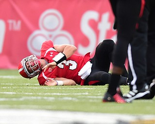 YOUNGSTOWN, OHIO - SEPTEMBER 6, 2014: Quarterback Dante Nania #3 of YSU lays on the ground in agony after being injured on a rollout during the 4th quarter of Saturday afternoon game at Stambaugh Stadium. YSU won 34-23. (Photo by David Dermer/Youngstown Vindicator)