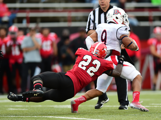 YOUNGSTOWN, OHIO - SEPTEMBER 6, 2014: Running back Ryan Ho #22 of Duquesne is tackled by defender Dubem Nwadiogbu #22 during the 4th quarter of Saturday afternoon game at Stambaugh Stadium. YSU won 34-23. (Photo by David Dermer/Youngstown Vindicator)