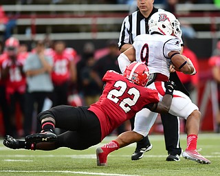 YOUNGSTOWN, OHIO - SEPTEMBER 6, 2014: Running back Ryan Ho #22 of Duquesne is tackled by defender Dubem Nwadiogbu #22 during the 4th quarter of Saturday afternoon game at Stambaugh Stadium. YSU won 34-23. (Photo by David Dermer/Youngstown Vindicator)