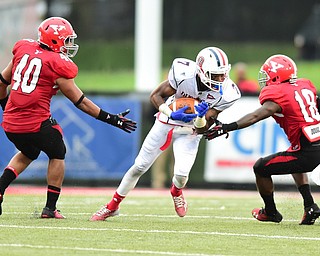 YOUNGSTOWN, OHIO - SEPTEMBER 6, 2014: Receiver Devin Rahming #7 of YSU spins away from would be tacklers Jaylin Kelly #40 and D.J. Thomas #18 on his way to the end zone for a touchdown during the 4th quarter of Saturday afternoon game at Stambaugh Stadium. YSU won 34-23. (Photo by David Dermer/Youngstown Vindicator)