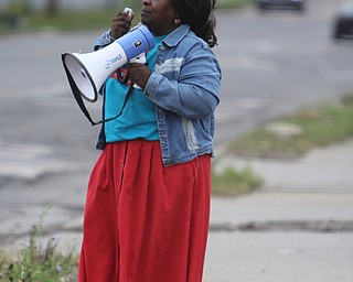 Pastor Martha Taylor uses a megaphone to draw people toward the Increase the Peace rally at Beulah Baptist Church in Youngstown on Saturday afternoon.  Dustin Livesay  |   The Vindicator  9/6/14  Youngstown.