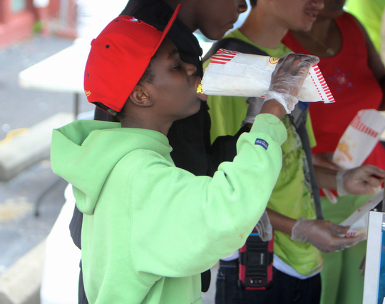 Walter Talley (11) of Youngstown eats a bag of popcorn during the Increase the Peace rally at Beulah Baptist Church in Youngstown on Saturday afternoon.  Dustin Livesay  |   The Vindicator  9/6/14  Youngstown.