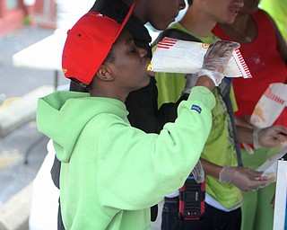 Walter Talley (11) of Youngstown eats a bag of popcorn during the Increase the Peace rally at Beulah Baptist Church in Youngstown on Saturday afternoon.  Dustin Livesay  |   The Vindicator  9/6/14  Youngstown.