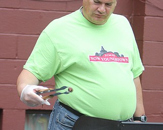 Dave Quigley of Youngstown prepares hot dogs during the Increase the Peace rally at Beulah Baptist Church in Youngstown on Saturday afternoon.  Dustin Livesay  |   The Vindicator  9/6/14  Youngstown.