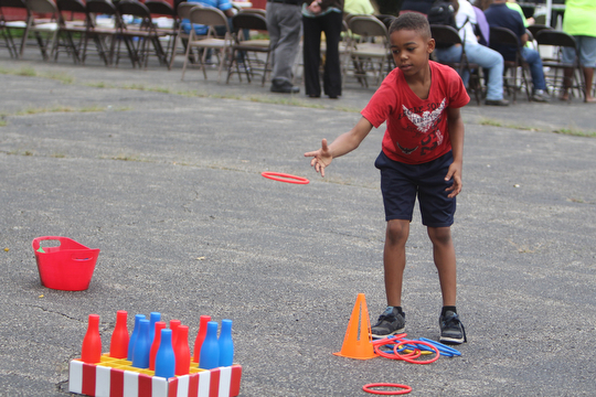 James Jackson (8) of Youngstown throws a ring at bottles during the Increase the Peace rally at Beulah Baptist Church in Youngstown on Saturday afternoon.  Dustin Livesay  |   The Vindicator  9/6/14  Youngstown.
