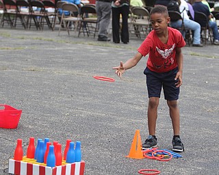 James Jackson (8) of Youngstown throws a ring at bottles during the Increase the Peace rally at Beulah Baptist Church in Youngstown on Saturday afternoon.  Dustin Livesay  |   The Vindicator  9/6/14  Youngstown.
