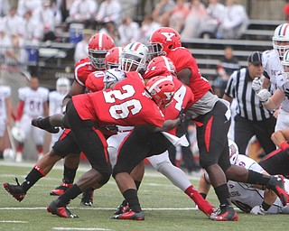 Duquesne running back Rafiq Douglas (30) gets wrapped up by a swarm of Youngstown State defenders led by Jameel Smith (26) and Eric Thompson (14) during the first quarter of Saturday evenings matchup at Stambaugh Stadium.  Dustin Livesay  |  The Vindicator  9/6/14  Stambaugh Stadium