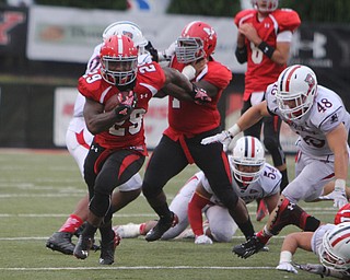 Youngstown State's Martin Ruiz (29) breaks through the Duquesne defense for a big gain during the fourth quarter of Saturday evenings matchup at Stambaugh Stadium.  Dustin Livesay  |  The Vindicator  9/6/14  Stambaugh Stadium