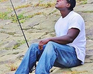 Jeff Lange | The Vindicator  Marquis Lindsey of Austintown sits back as he watches his pole bend from a bite, Saturday morning at the Meander Reservoir.