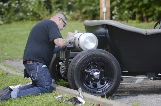 Katie Rickman | The Vindicator.Bob McElroy of Salem does pin striping on a 1923 T-Bucket  at the second annual Rust Belt car show and artist market at the B&O station September 7, 2014.