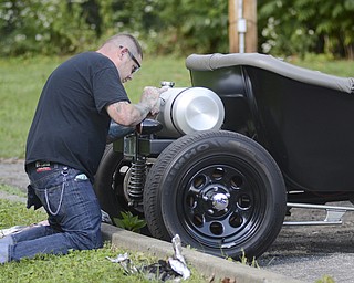 Katie Rickman | The Vindicator.Bob McElroy of Salem does pin striping on a 1923 T-Bucket  at the second annual Rust Belt car show and artist market at the B&O station September 7, 2014.