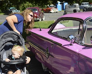 Katie Rickman | The Vindicator.Tracy Kahl of Austintown looks at the interior of a 1960 Chevy Impala as her her son Donovin Robertson, 15 months, sits in his stroller at the second annual Rust Belt car show and artist market at the B&O station September 7, 2014.