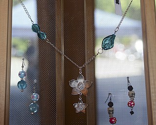 Katie Rickman | The Vindicator.Necklaces and earrings on display at Riversong Designs booth owned by Erica Perna of Niles at the second annual Rust Belt car show and artist market at the B&O station September 7, 2014.