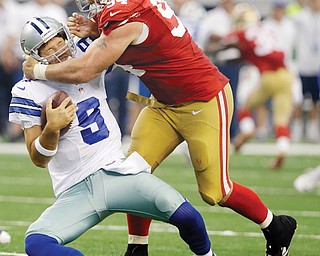 Cowboys quarterback Tony Romo (9) is sacked by San Francisco 49ers defensive end Justin Smith (94) during
the second half of their NFL game Sunday at AT&T Stadium in Arlington, Texas. The 49ers sacked Romo three
times and intercepted three Cowboy passes on their way to a 28-14 win. 