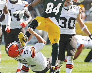 Browns punter Spencer Lanning (5) is kicked in the face mask by a leaping Antonio Brown (84) of the Steelers as Brown returns a punt in the second quarter of their NFL game Sunday at Heinz Field in Pittsburgh. Brown was penalized for unnecessary roughness. Cleveland rallied in the second half to tie the game, but a 41-yard field goal by Shaun Suisham with 47 seconds remaining gave the Steelers the 30-27 win.