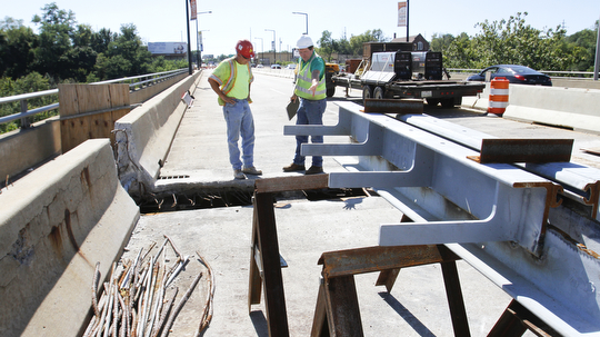        ROBERT K. YOSAY  | THE VINDICATOR..Randy Partika - Mahoning county bridge engineer and Tony Gaglione (red helmet )of B>G>Trucking and Construction  sub contractor ....Randy Partika - Mahoning county bridge engineer andlook at the under layment of steel where the expansion joints are being replaced.. As it undergoes its first major rehabilitation in the 31 years since it opened, work will continue on the Vietanam Veterans Memorial  bridge through November, Mahoning CountyÕs bridge engineer said..The reduction to one lane in each direction for painting and rehabilitation began July 28 and will continue through November...  .....  -30-