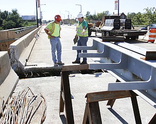        ROBERT K. YOSAY  | THE VINDICATOR..Randy Partika - Mahoning county bridge engineer and Tony Gaglione (red helmet )of B>G>Trucking and Construction  sub contractor ....Randy Partika - Mahoning county bridge engineer andlook at the under layment of steel where the expansion joints are being replaced.. As it undergoes its first major rehabilitation in the 31 years since it opened, work will continue on the Vietanam Veterans Memorial  bridge through November, Mahoning CountyÕs bridge engineer said..The reduction to one lane in each direction for painting and rehabilitation began July 28 and will continue through November...  .....  -30-