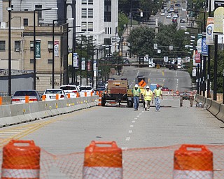        ROBERT K. YOSAY  | THE VINDICATOR..Randy Partika - Mahoning county bridge engineer Dennis Gertko  and Tony Gaglione of B>G>Trucking and Construction  look at the under layment of steel where the expansion joints are being replaced.. As it undergoes its first major rehabilitation in the 31 years since it opened, work will continue on the Vietanam Veterans Memorial  bridge through November, Mahoning CountyÕs bridge engineer said..The reduction to one lane in each direction for painting and rehabilitation began July 28 and will continue through November...  .....  -30-