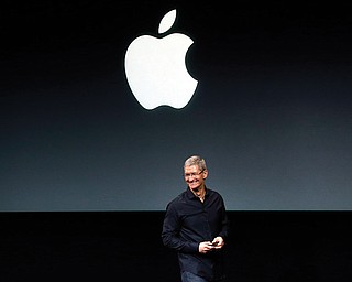 Apple CEO Tim Cook speaks on stage before a new-product introduction in Cupertino, Calif. Apple is poised to reveal its next big thing today in a crucial attempt to prove its technological tastemakers still have the power to mesmerize the masses.