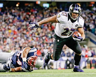 Baltimore Ravens running back Ray Rice goes in for a 2-yard touchdown run against the New England Patriots during the first half of the AFC Championship in Foxborough, Mass. Hours after the release of a video that appears to show Rice striking his then-fiancee in February, the team terminated his contract Monday.
