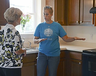 Katie Rickman | The Vindicator.Kathy Mock who is on the Board of Education in Austintown tours the house as Monica Craven who is the executive director of Habitat for Humanity of Mahoning County explains the layout of the handicap accessible home on Tuesday, Sept. 9, 2014.