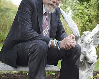 Katie Rickman | The Vindicator.Rev. Ric Schumacher poses for a photo in the Angel Garden where a candle-lit service will be held Wednesday Sept. 9, 2014 as a part of a world prayer service for the Unity's World Day of Prayer.