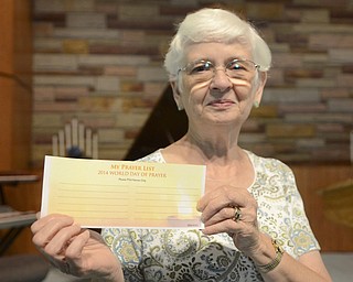Katie Rickman | The Vindicator.Lynn Denning of Cortland holds up a prayer card at Unity Center for Spiritual Living in Liberty Tuesday, Sept 9, 2014. The congregation of the center will be participating in a world-wide prayer day Wednesday.