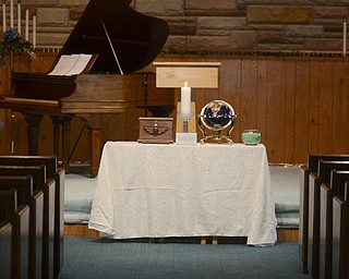 Katie Rickman | The Vindicator.A candle is lit at the front of the sanctuary at Unity Centre for Spiritual Living on Tuesday, Sept. 9 , 2014.  The congregation's partitioners will take part in a world-wide prayer day Wednesday.