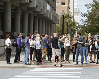        ROBERT K. YOSAY  | THE VINDICATOR.. Phil Kidd Owner of  Youngstown Nation and Defend Youngstown takes the students on a tour of the downtown area....Canfield High School Honors English students explore Youngstown and Rust Belt culture and downtown buildings as they toured downtown to talk about the architecture and the history of the buildings..  -30-