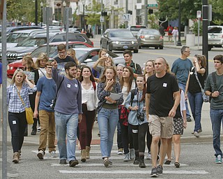        ROBERT K. YOSAY  | THE VINDICATOR.. Phil Kidd Owner of  Youngstown Nation and Defend Youngstown takes the students on a tour of the downtown area....Canfield High School Honors English students explore Youngstown and Rust Belt culture and downtown buildings as they toured downtown to talk about the architecture and the history of the buildings..  -30-
