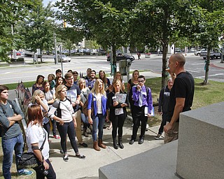        ROBERT K. YOSAY  | THE VINDICATOR.. Phil Kidd Owner of  Youngstown Nation and Defend Youngstown takes the students on a tour of the downtown area....Canfield High School Honors English students explore Youngstown and Rust Belt culture and downtown buildings as they toured downtown to talk about the architecture and the history of the buildings..  -30-