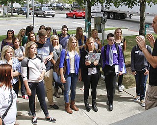        ROBERT K. YOSAY  | THE VINDICATOR.. Phil Kidd Owner of  Youngstown Nation and Defend Youngstown takes the students on a tour of the downtown area....Canfield High School Honors English students explore Youngstown and Rust Belt culture and downtown buildings as they toured downtown to talk about the architecture and the history of the buildings..  -30-