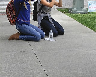        ROBERT K. YOSAY  | THE VINDICATOR..Sarah Heaven and Abby Karlovic use their phones to shoot the Stambaugh building  Canfield High School Honors English students explore Youngstown and Rust Belt culture and downtown buildings as they toured downtown to talk about the architecture and the history of the buildings...  -30-