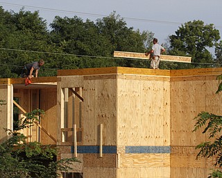        ROBERT K. YOSAY  | THE VINDICATOR..Workers for DAV construction carry wood beams as they complete the second of four floors in the new Holiday Inn Express in Salem..The city of Salem received more than $1.85 million from leasing rights on city property, said Mayor John Berlin. Salem used $650,000 to pay down debt from the cities efforts to revitalize the downtown and improve roads for economic development..The hotel will be the only one in Salem and represents just a part of the economic development in the city....  -30-       ROBERT K. YOSAY  | THE VINDICATOR...  -30-